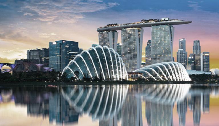 The stunning architecture of downtown Singapore casts a dazzling reflection in the city’s harbor.
