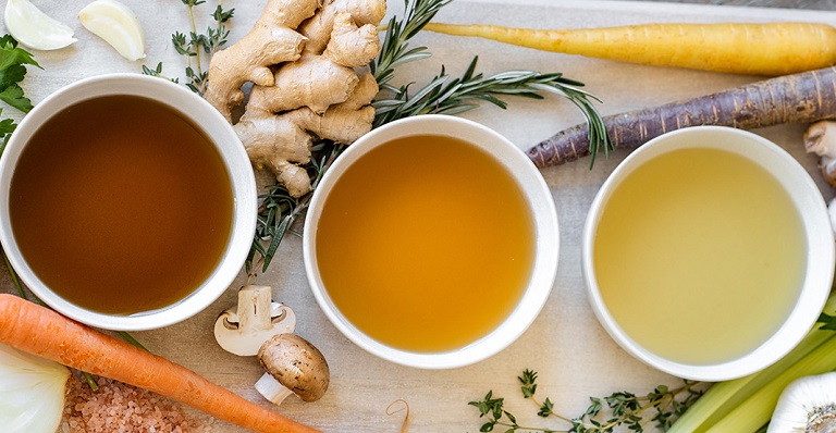 Bowls of delicious soup are served on a platter.
