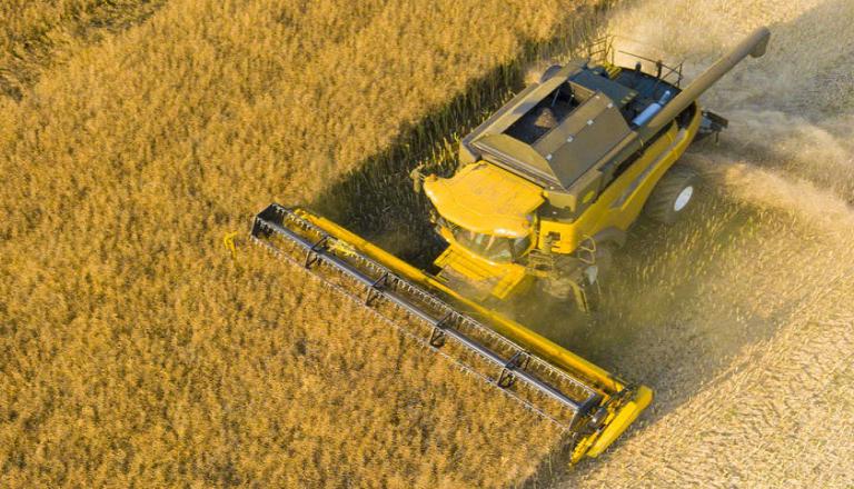 Farmer operating heavy machinery tending to the crops