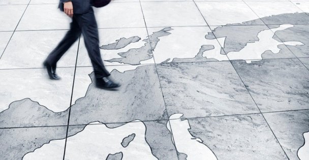 Man walking on floor map of Europe.
