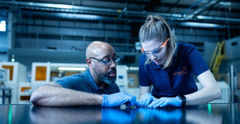 Two employees working in a high tech setting