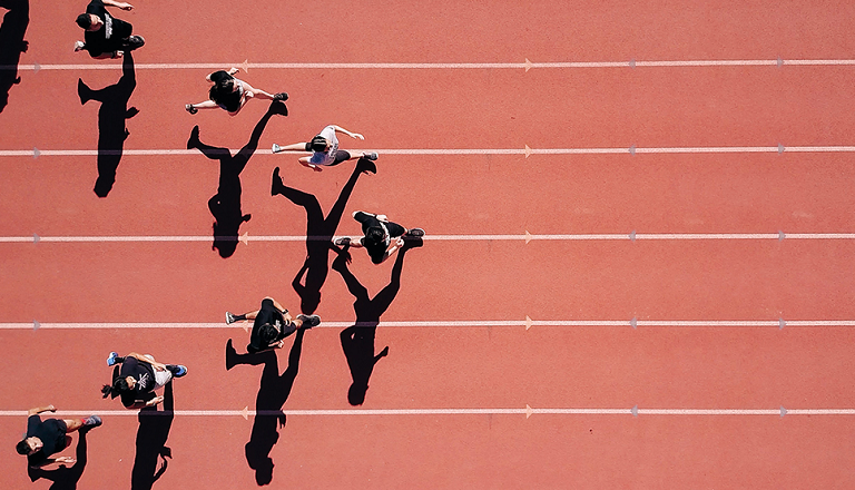 Viewed from above, athletes run on a track in a V formation.