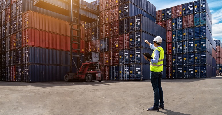 Port worker monitors shipping container logistics